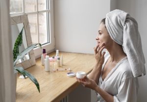 A young woman applying salicylic acid cream