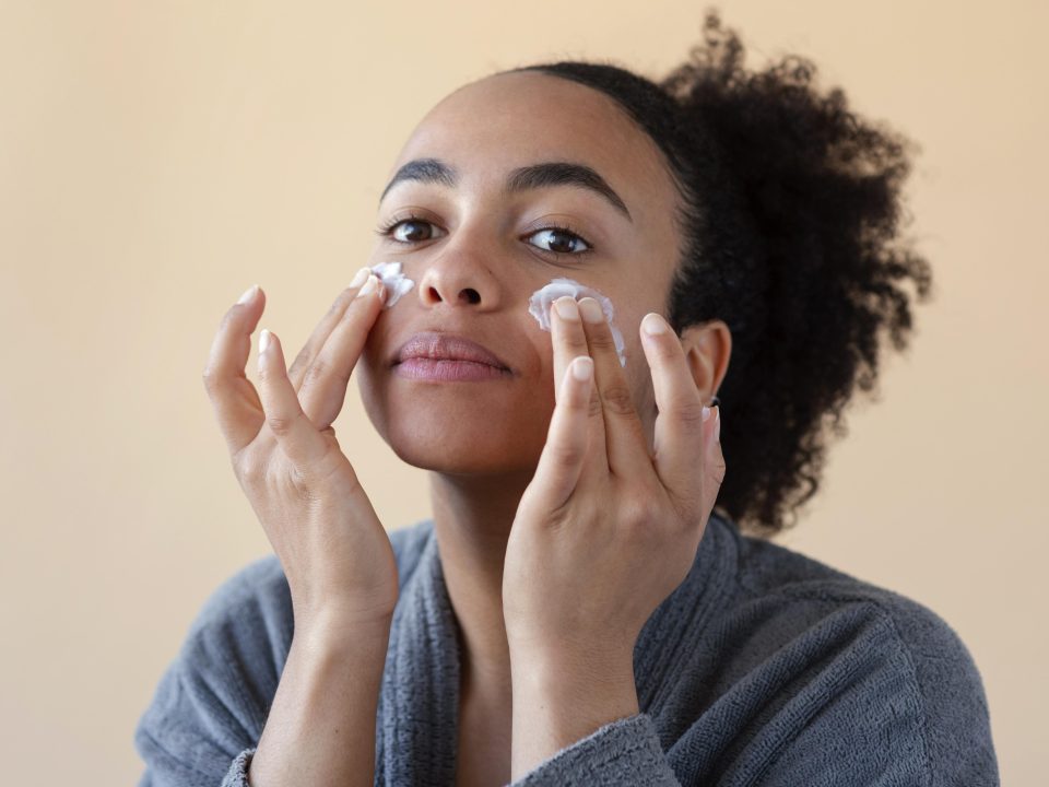 A woman applying cream with salicylic acid