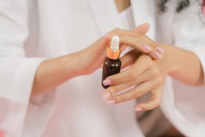 A person applying a salicylic acid on the hand