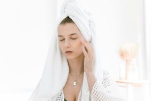 A woman applying salicylic acid on her face