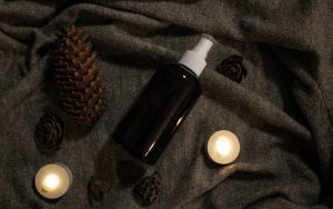 A salicylic acid bottle with candles arranged on a black cloth