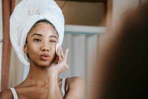 A woman applying salicylic acid on her face