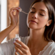 A woman applying salicylic acid to her face