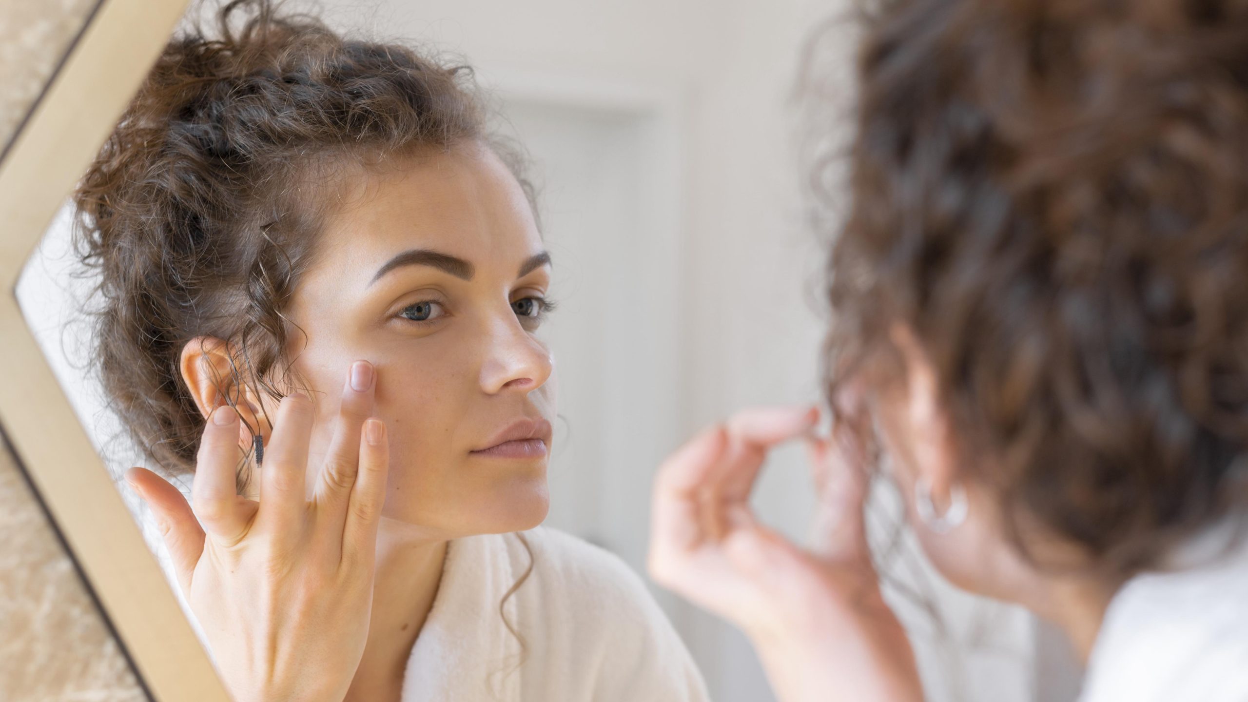 A woman applying lactic acid on her face